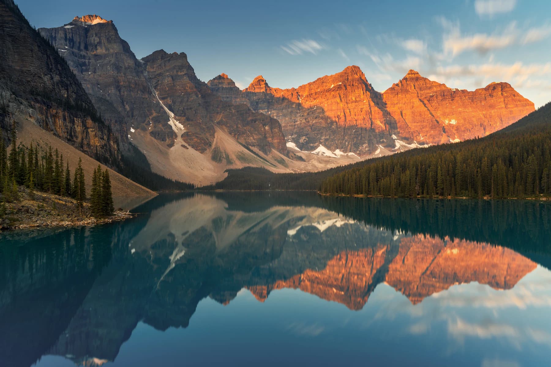 Mountain peaks reflected in the turquoise water of Moraine Lake in Banff National Park